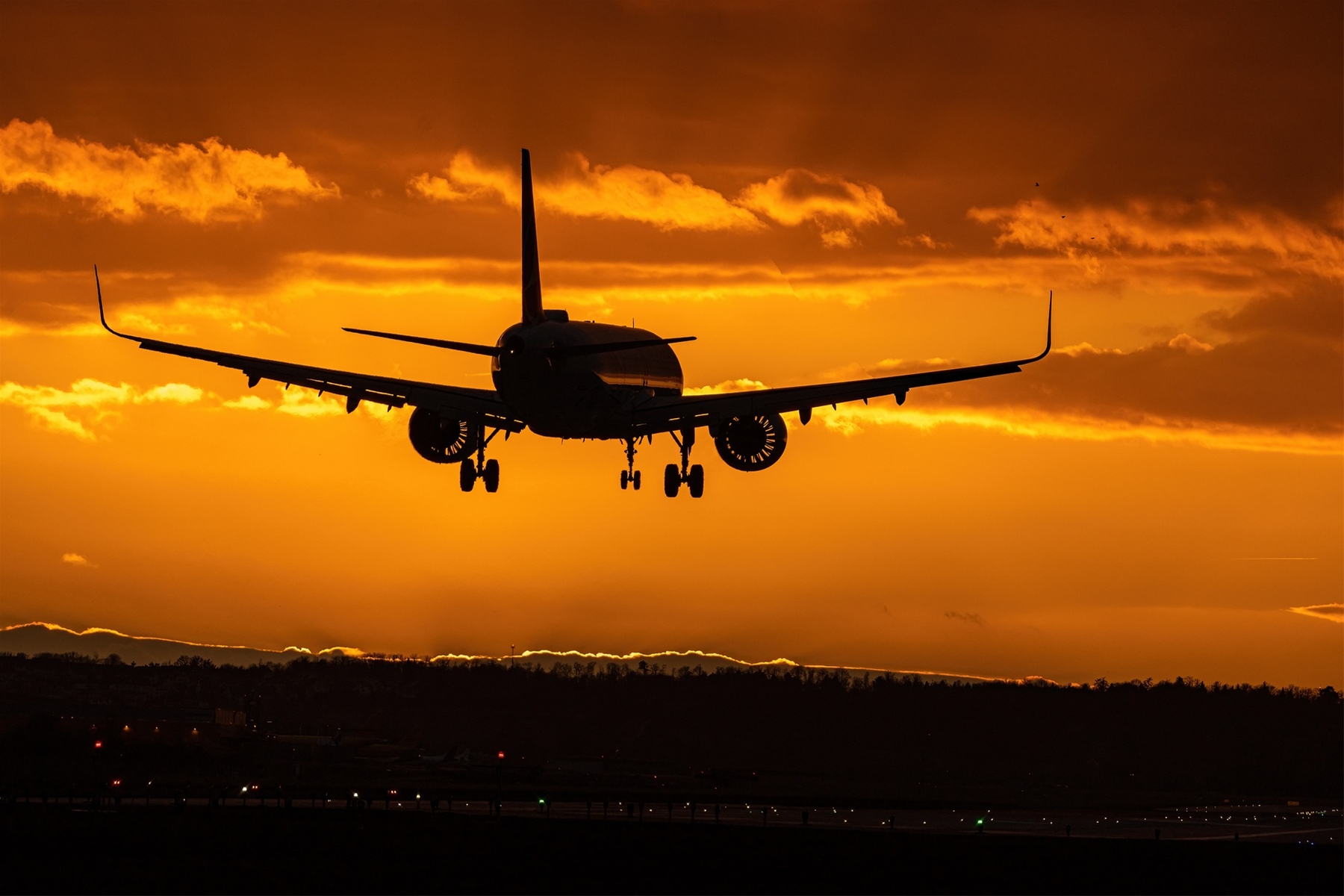 Plane Taking Off At Sunset